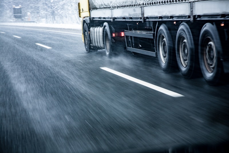 Truck Driving on Wet Slippery Road in Winter